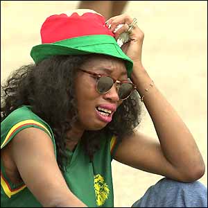 A distraught Cameroon fan sobs after hearing that Marc-Vivien Foe has died