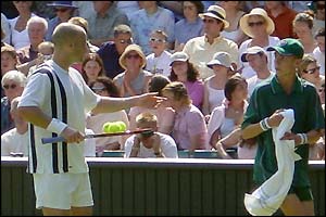 Andre Agassi asks for a towel from the ball boy