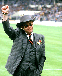 Elton John waves to fans at Wembley at the 1984 FA Cup final against Everton, which Watford lost