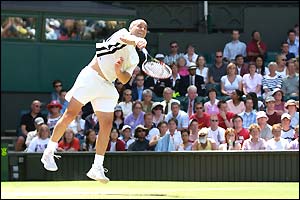 Andre Agassi serves during his game with Younes El Aynaoui 