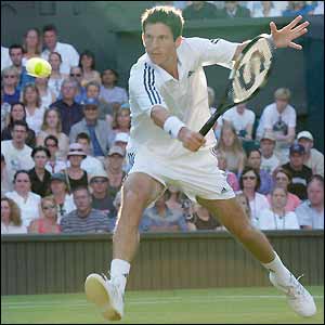 Tim Henman stretches for a backhand volley