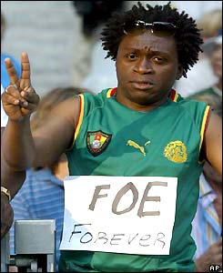 A Cameroon fan pays his respects to Foe at the stadium