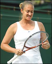 Mary Pierce grimaces as she adjusts her racket during her defeat to Justine Henin-Hardenne