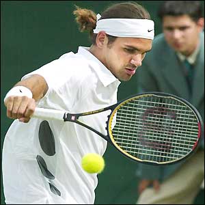 Roger Federer hits a backhand