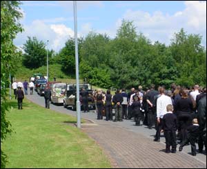 The procession included three pick up vans covered in flowers