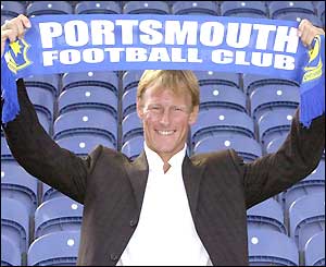 Teddy Sheringham holds up a Portsmouth scarf