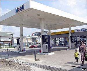 A woman and her child at a petrol station