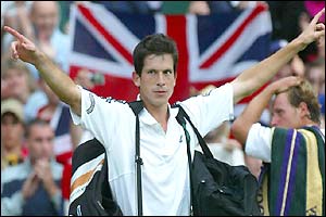 Tim Henman salutes the fans on Centre Court after his victory