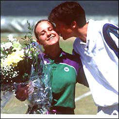 Caroline Hall receives a peck on the cheek from Tim Henman