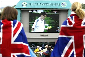 Fans at Wimbledon watch Tim Henman play Lleyton Hewitt on a giant screen