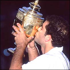Pete Sampras kisses the Wimbledon trophy