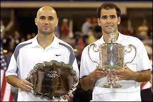 Pete Sampras poses with Andre Agassi after winning the US Open in 2002