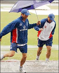 Michael Vaughan and bowler Darren Gough enjoy the rain at Headingley