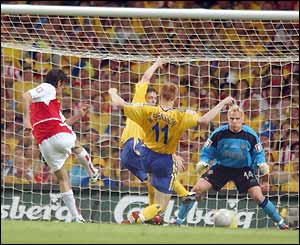 Arsenal's Robert Pires scores the first goal of the game
