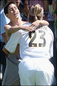 A fan runs onto the training pitch and embraces David Beckham