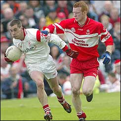 Derry's Fergal Doherty tries to stop Brian McGuigan of Derry