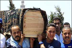 Mourners carry a bomb victim's coffin
