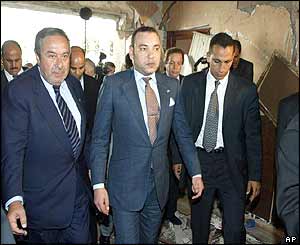 King Mohammed VI (centre) tours bomb site