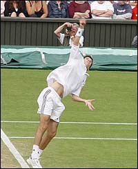 Tim Henman serves against David Nalbandian