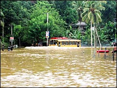 A bus tries to drive people away from the floods: Courtesy Sriyantha Walpola