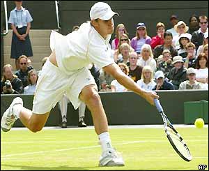 Andy Roddick stretches forward to make a volley