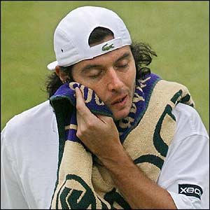 Sebastien Grosjean wipes his face after being broken in the first game of the second set 