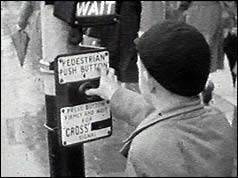 Schoolboy pressing button at crossing 