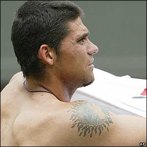 Mark Philippoussis changes his shirt after winning the second set 