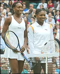 Serena Williams and Venus Williams stand either side of the net after the toss