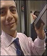 Ibrahim Hilal with a tape showing dead US troops