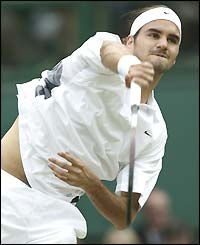 Roger Federer serves