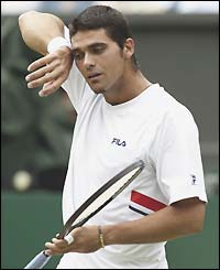 Mark Philippoussis wipes his forehead on his sweatband