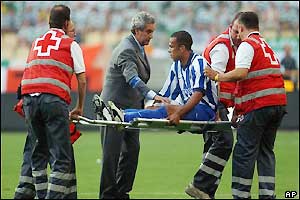 FC Porto's Costinha is taken off the field
