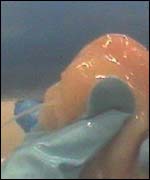 Water being squeezed out of a chicken fillet