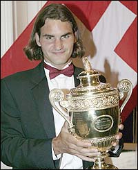 Roger Federer holds the men's trophy aloft
