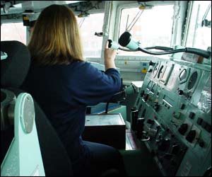 One of the school children sitting in the captain's chair