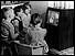 Children watching black and white TV