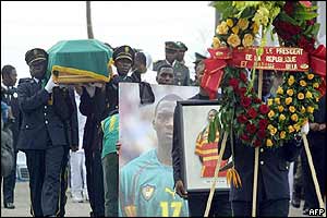 Police officers carry the coffin of Marc Vivien Foe
