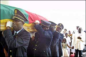Police officers carry the coffin as they arrive at the Notre Dame des Victoires cathedral 