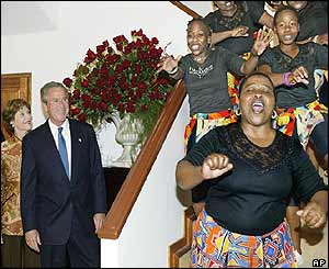 Mr and Mrs Bush watch singers in South Africa