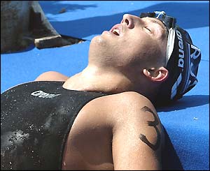 Yevgeny Kochkarov of Russia celebrates winning the 5km open water event