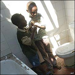 Children in a destroyed bathroom