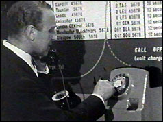 Post Master General Ernest Marples demonstrates use of a public phone box