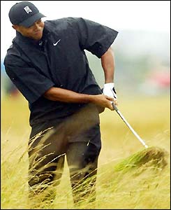 Tiger Woods plays out of the rough