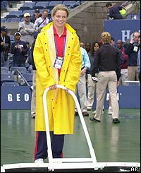 Kim Clijsters helps clear the courts at the US Open