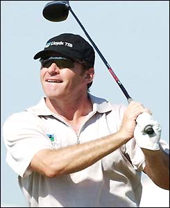 Nick Faldo plays a drive
