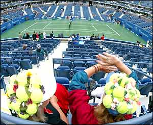 Fans wait patiently in the stands on the Arthur Ashe court
