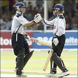 Jim Troughton celebrates with team-mate Trevor Penney after the pair help Warwickshire to victory