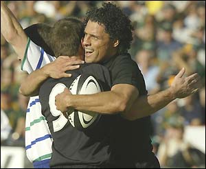 Wing Doug Howlett is congratulated after scoring New Zealand's second try