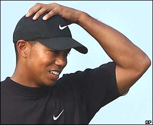 Tiger Woods holds his head in frustration